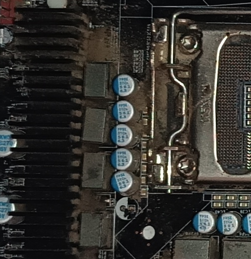 Close-up showing the empty solder pads where a capacitor is missing beside the CPU socket