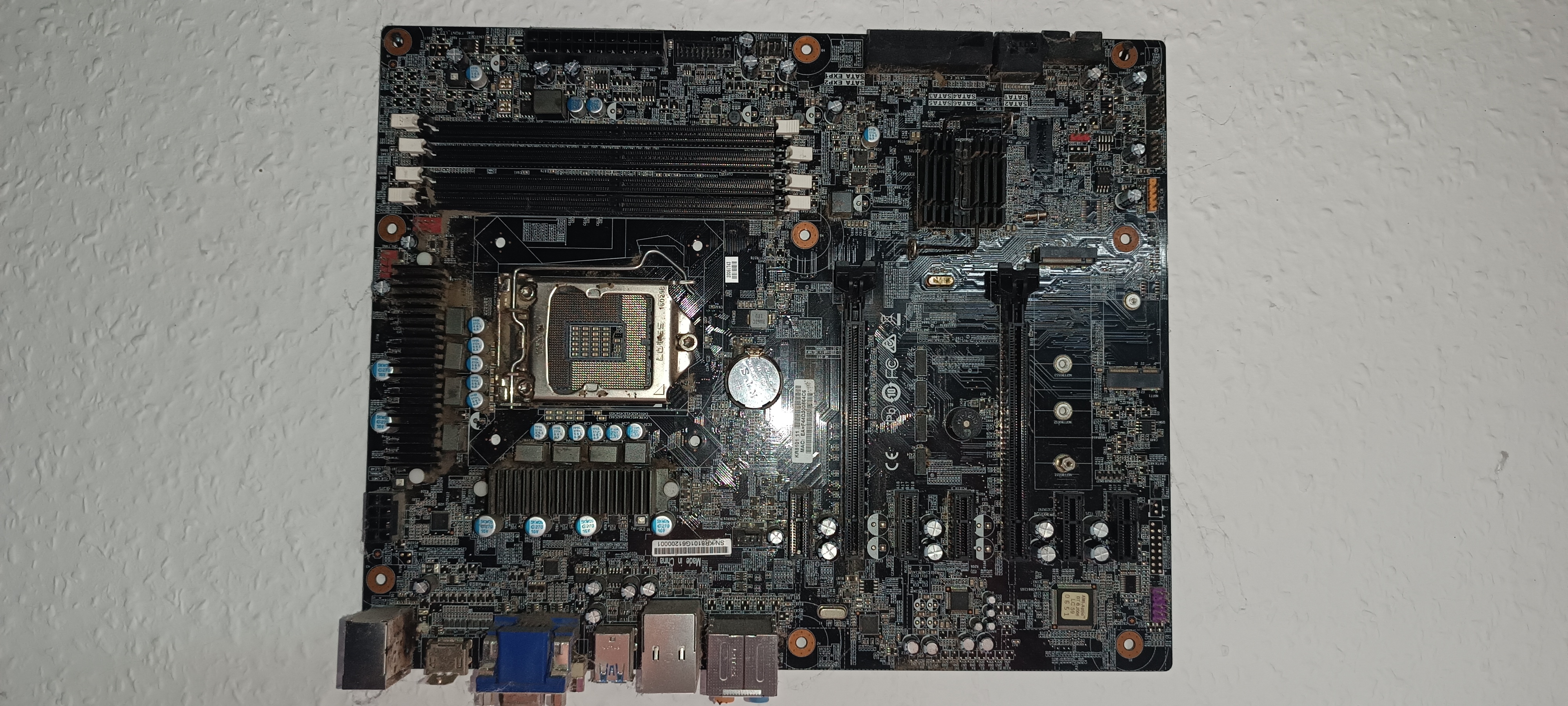 Retired motherboard with a missing capacitor beside the CPU socket