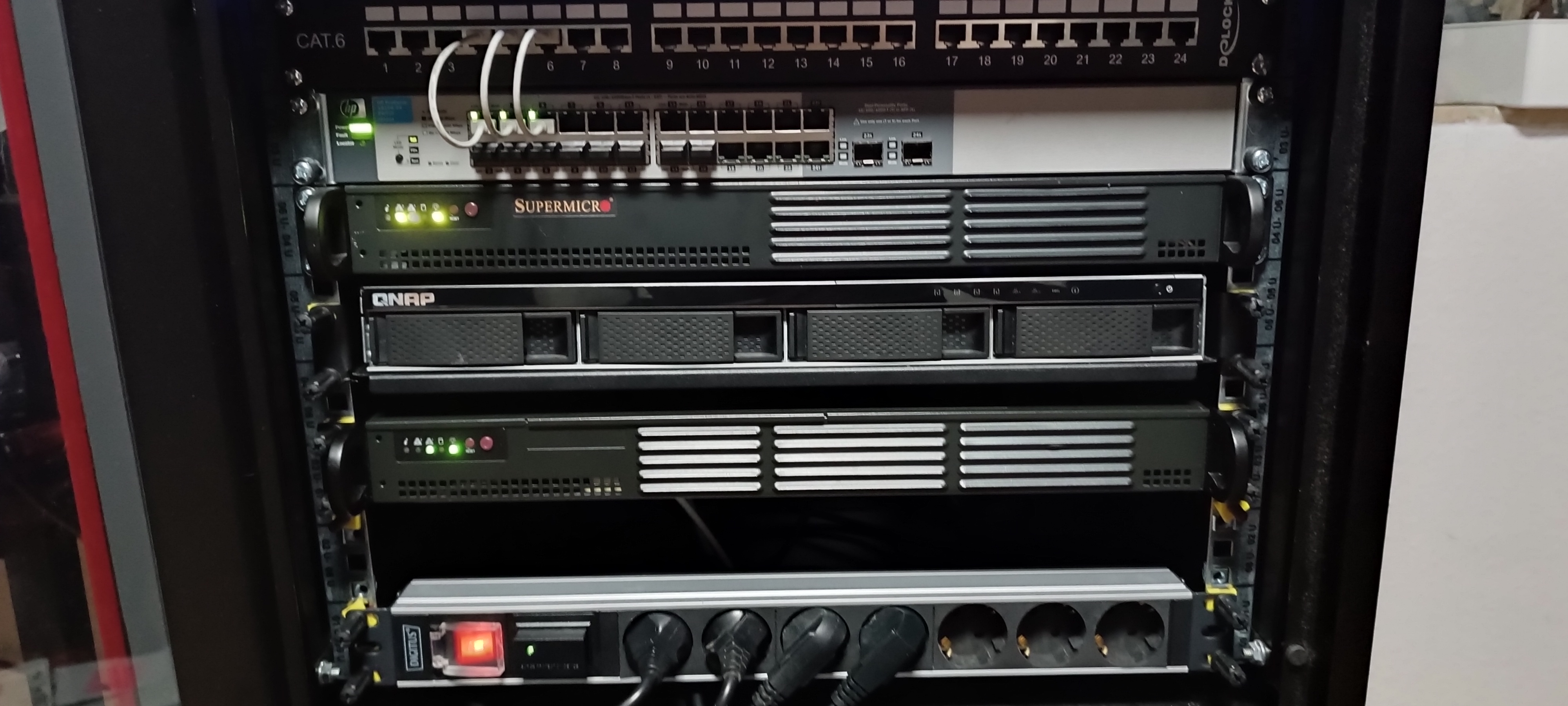 A home server rack with network switch, servers, and storage.