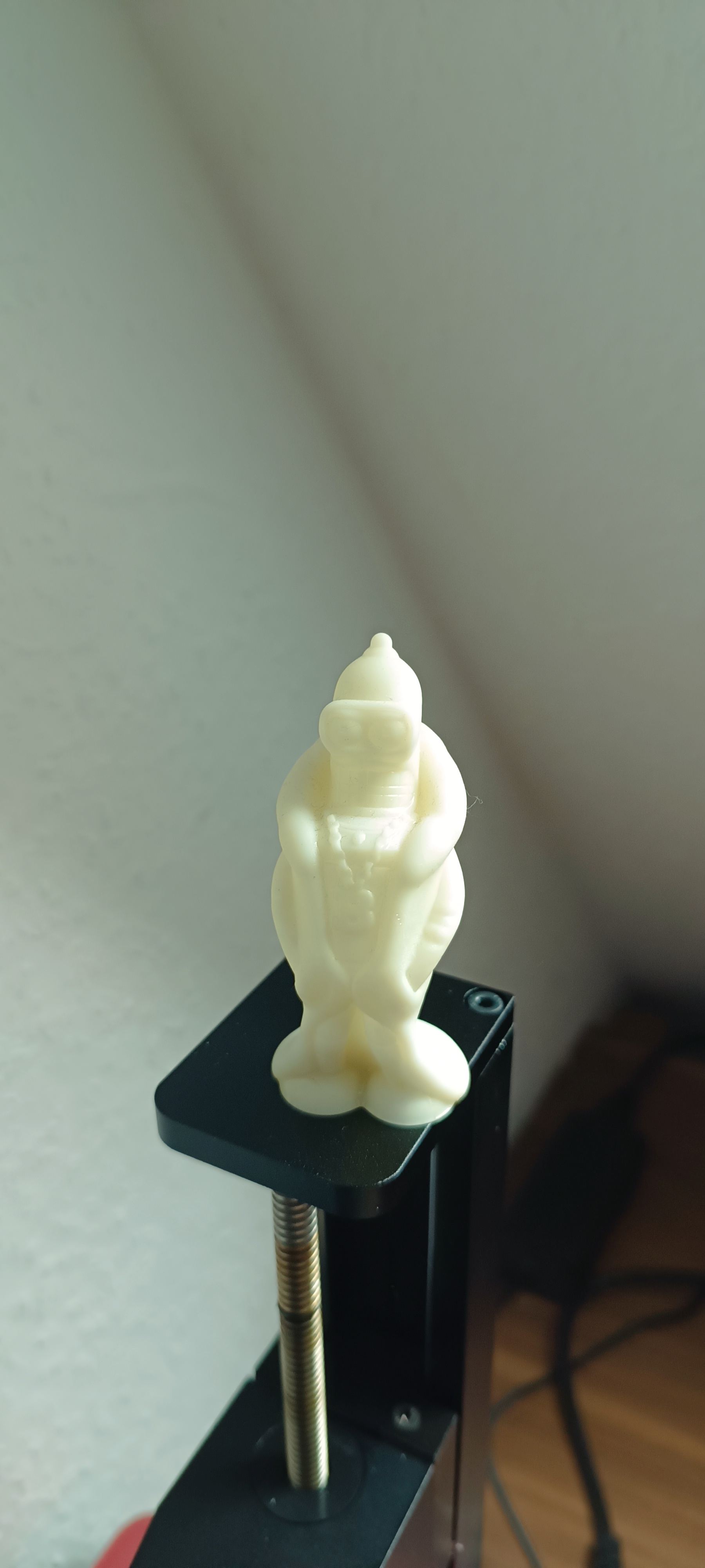 An unfinished white 3D-printed Bender figure.